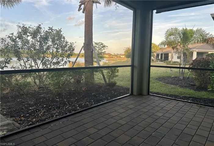 Unfurnished sunroom featuring a water view