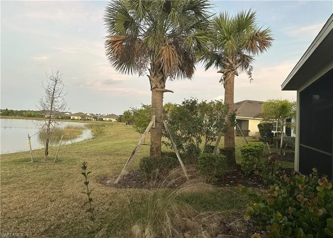 View of green lawn featuring a water view