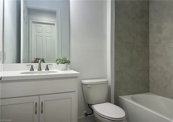 Full bathroom with vanity and toilet