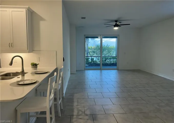 Dining space featuring ceiling fan and light tile patterned floors