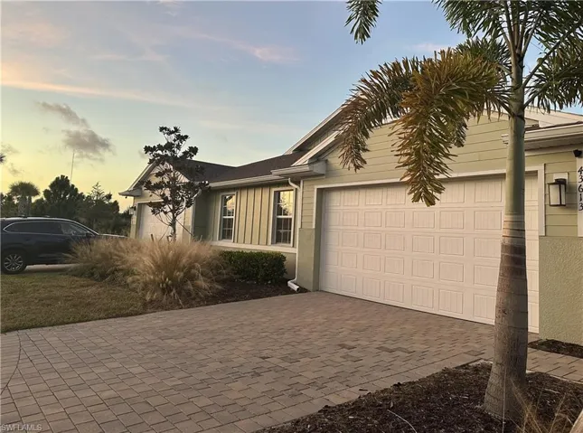Ranch-style home with decorative driveway and a garage
