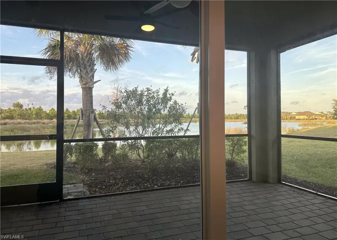 Unfurnished sunroom featuring a water view