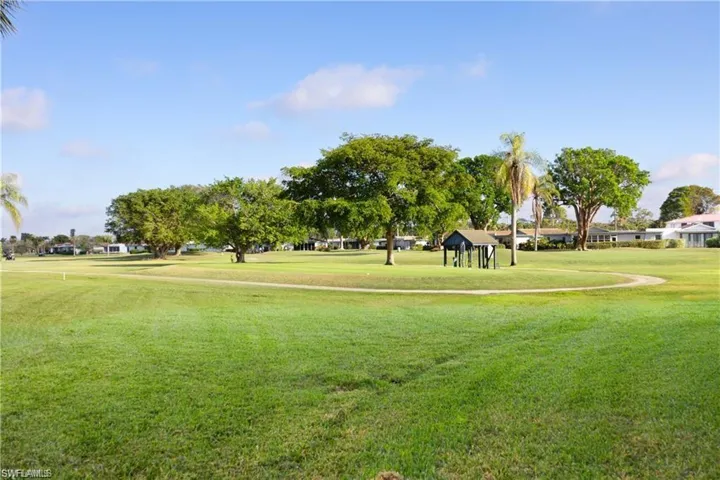 View of community featuring a gazebo, a yard, and golf course view