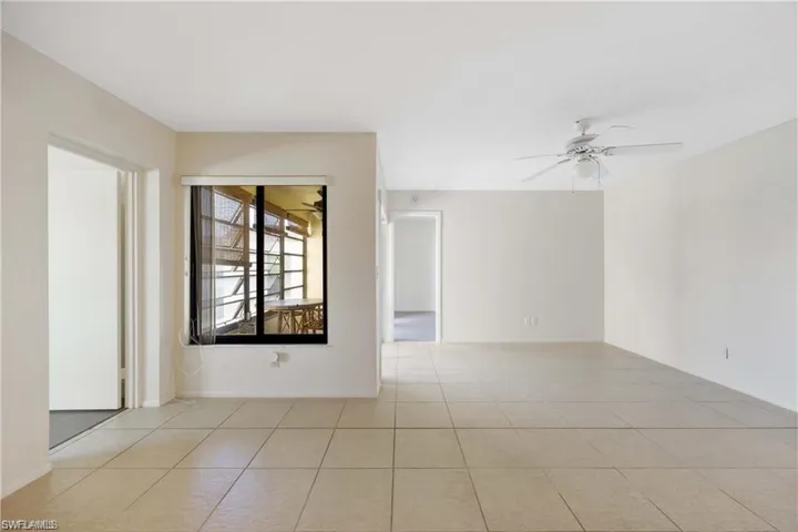Unfurnished room featuring a ceiling fan and light tile patterned floors