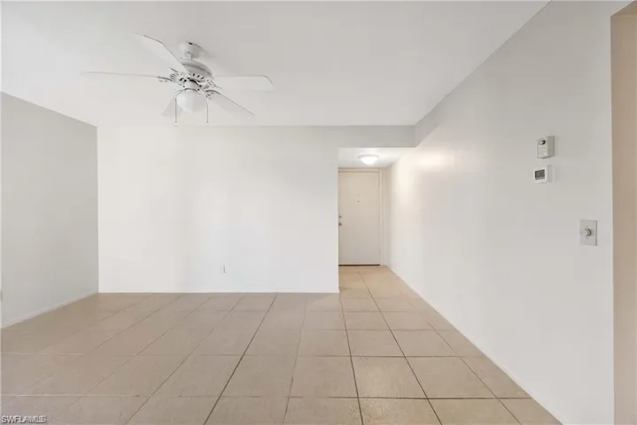 Spare room with light tile patterned floors and ceiling fan