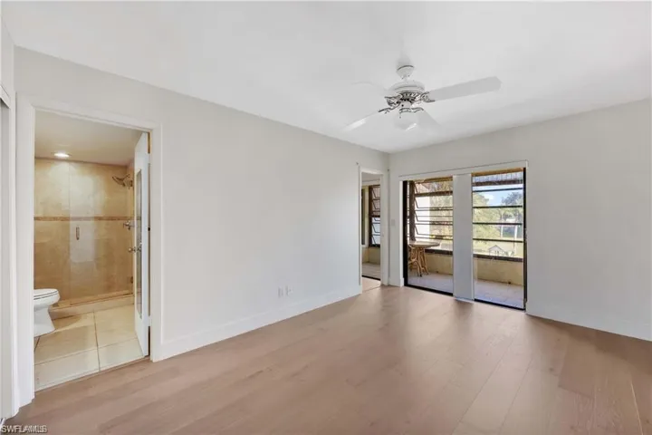 Spare room with light wood finished floors and ceiling fan