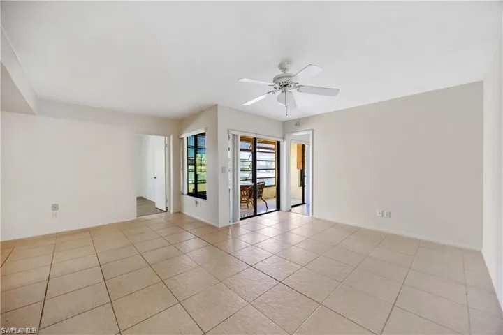 Spare room featuring ceiling fan and light tile patterned floors