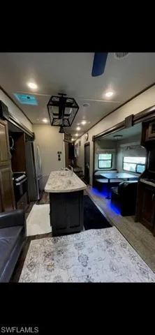 Kitchen with light countertops, a center island, and freestanding refrigerator