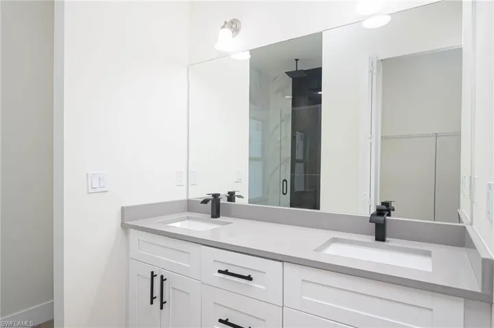 Bathroom with vanity and an enclosed shower