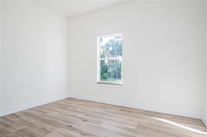 Spare room featuring light wood-type flooring