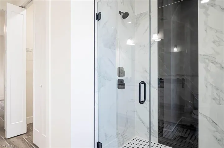 Bathroom featuring a shower with door