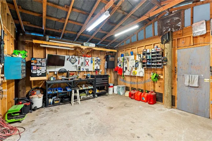 Pole barn with a workshop area and wood walls