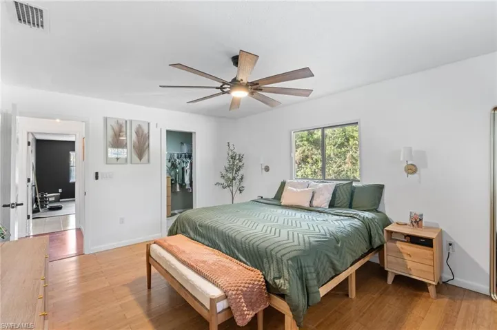 Bedroom featuring a walk in closet and light wood-style flooring