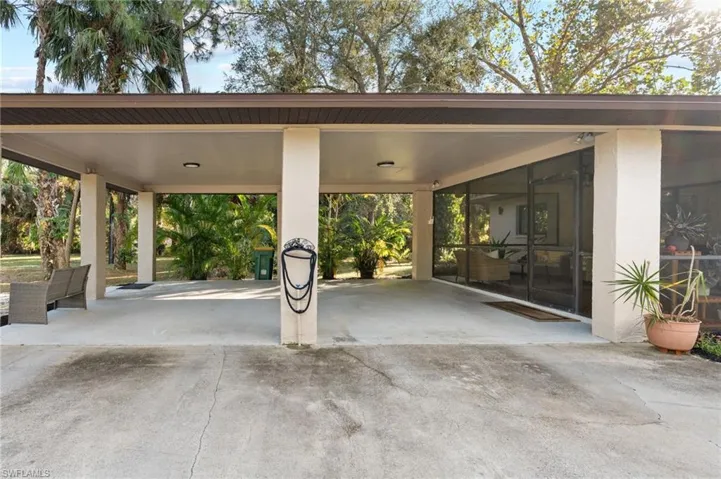 View of patio with driveway and an attached carport
