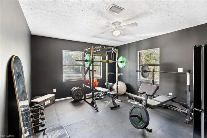 Workout room featuring rubber floors