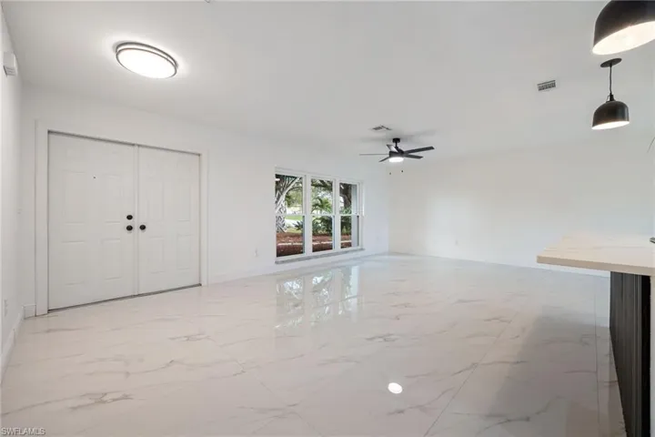 Entryway with light marble finish flooring and a ceiling fan