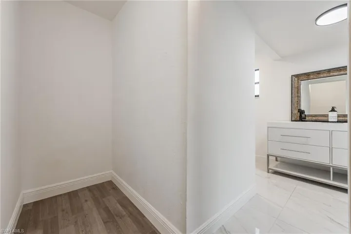 Hall featuring baseboards and light wood finished floors
