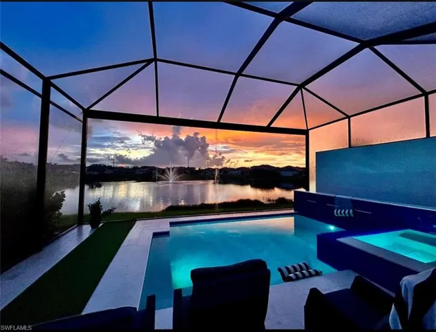 View of pool featuring a sunroom and a pool with connected hot tub