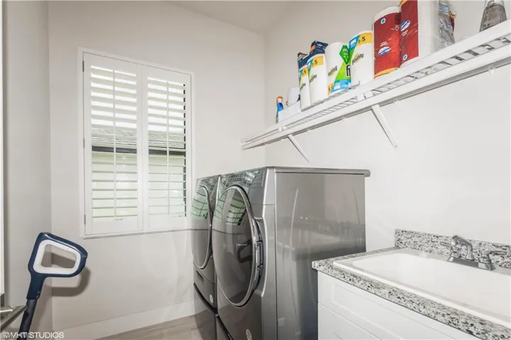 Laundry room featuring washer and dryer and wood finished floors