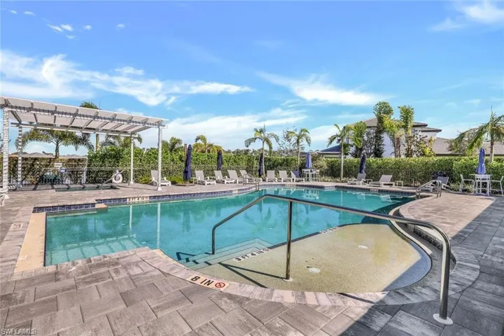 Community pool featuring a pergola, fence, and a patio area