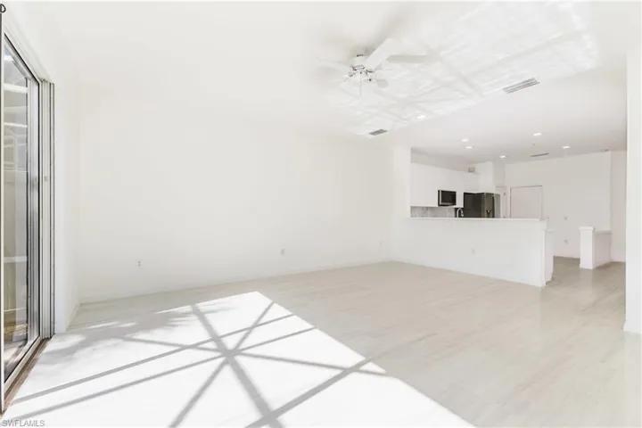 Unfurnished living room featuring ceiling fan, light wood-type flooring, and recessed lighting