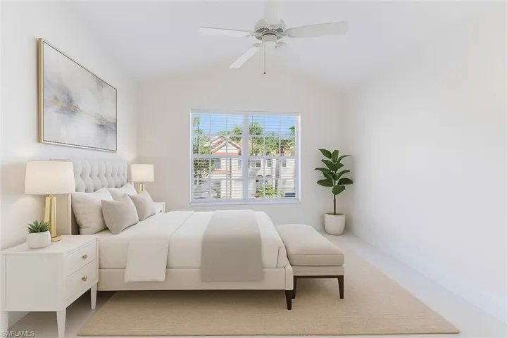 Bedroom featuring lofted ceiling, ceiling fan, and carpet floors