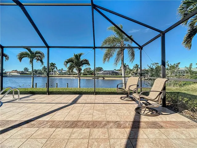 View of patio featuring a lanai and a water view