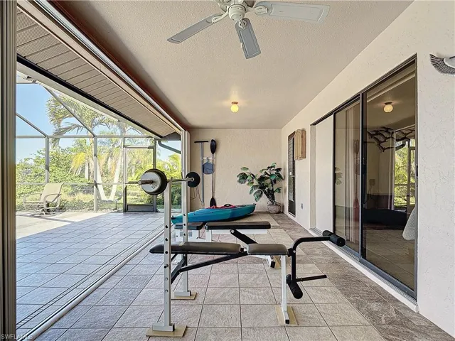 Workout room featuring a textured ceiling and ceiling fan