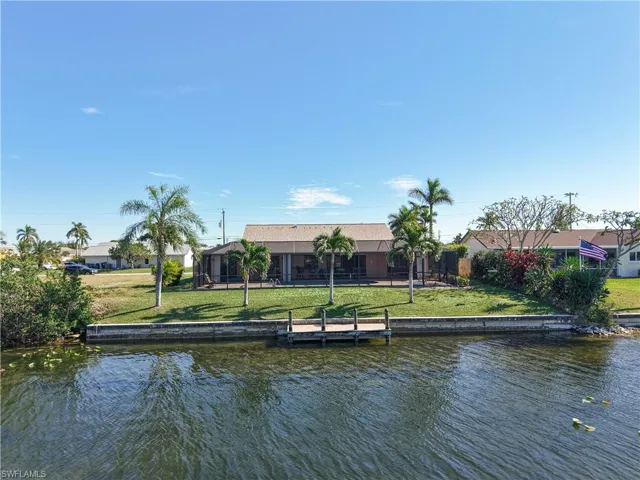 Dock area featuring a lawn and a water view
