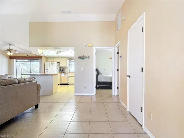 Corridor featuring a wealth of natural light and light tile patterned flooring