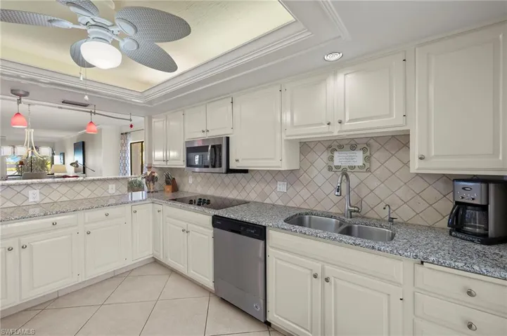 Kitchen with white cabinetry, sink, and stainless steel appliances