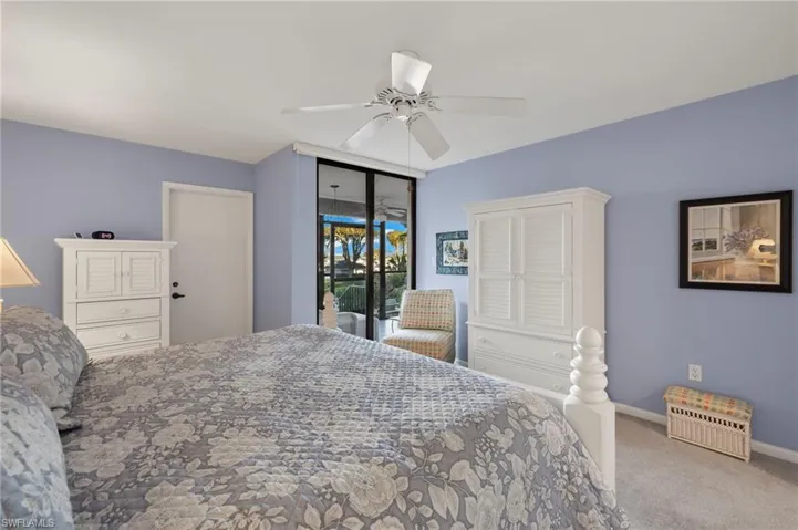 Carpeted bedroom featuring ceiling fan and access to outside