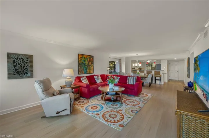 Living room featuring light hardwood / wood-style floors and ornamental molding
