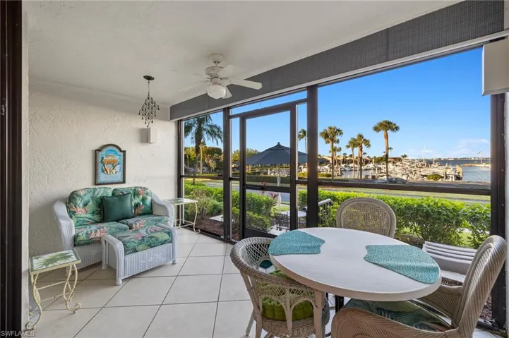 Sunroom featuring a water view and ceiling fan