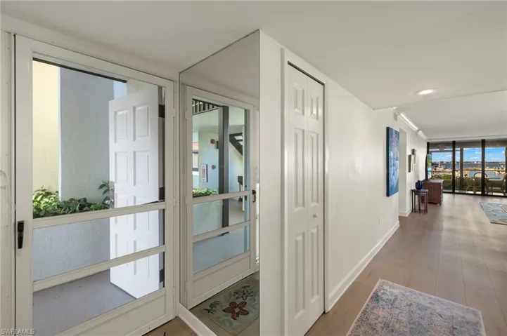 Hall with hardwood / wood-style floors