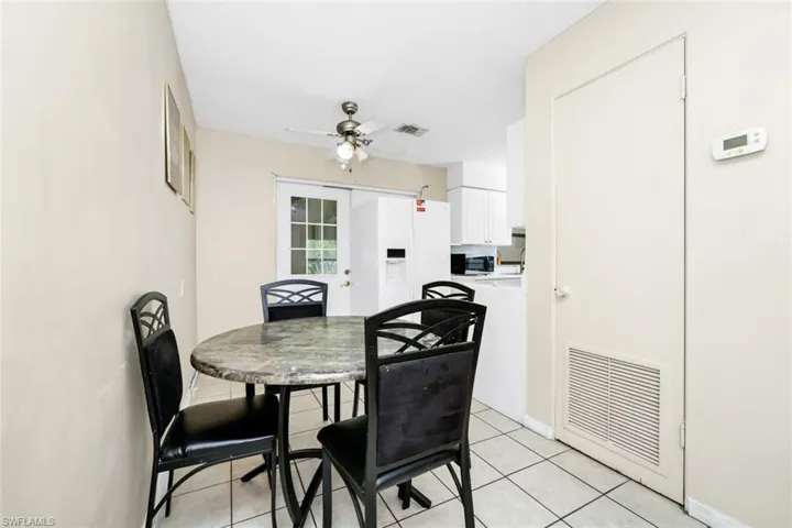 Dining room featuring a ceiling fan, visible vents, and light tile patterned floors