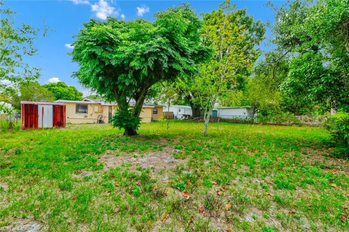 View of yard with a storage unit and an outbuilding