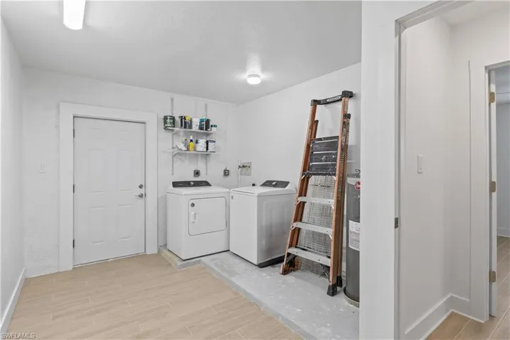 Convenient laundry room with ample space for washer, dryer, and storage.