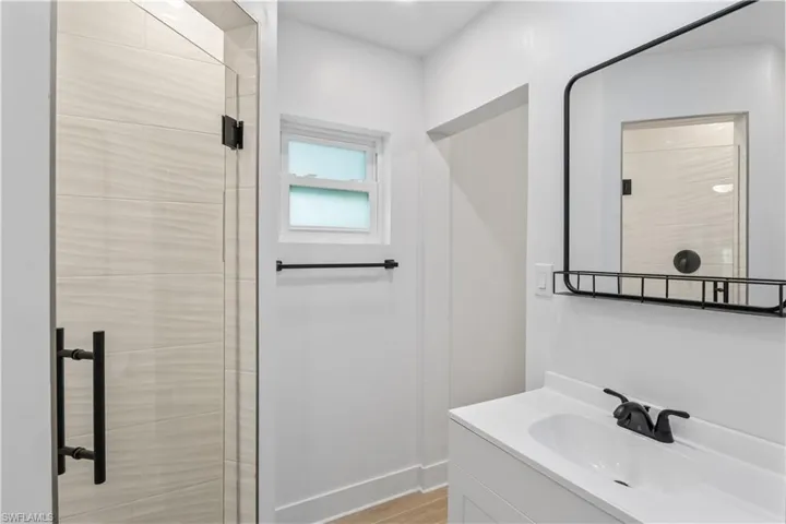 Updated bathroom featuring stylish new tile in the spacious walk-in shower.