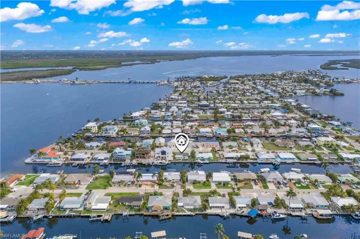 Stunning aerial view showcasing the property’s direct access to Matlacha Pass and open water.