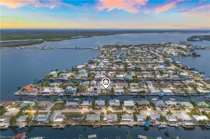 Bird’s-eye perspective of the charming island community, canals, and Gulf access.