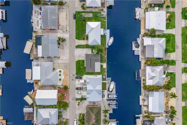 Elevated aerial view showcasing the home’s footprint, roofline, and lot layout.