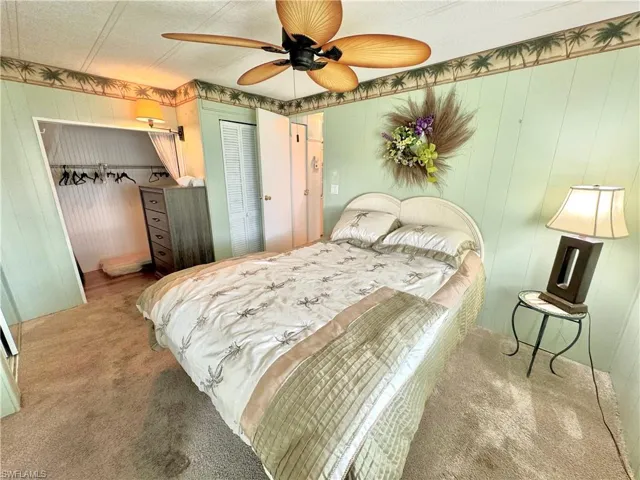 Guest Bedroom with ceiling fan, a textured ceiling, and carpet flooring