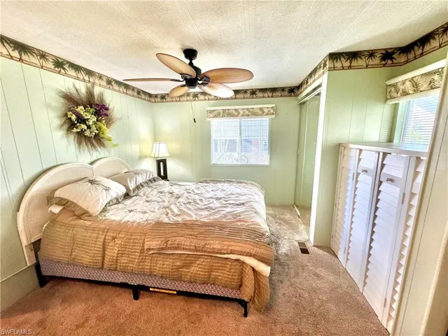 Guest Bedroom featuring carpet, ceiling fan, and a textured ceiling