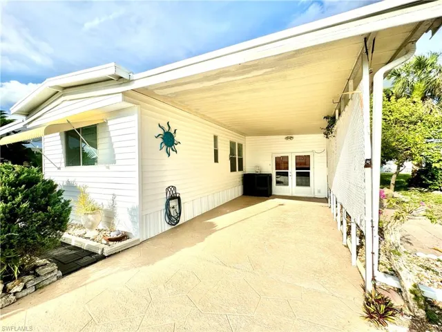View of patio with a carport