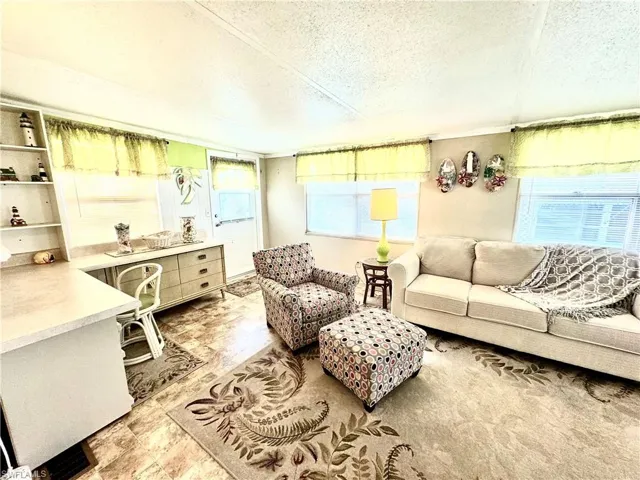 Tiled living room with a textured ceiling