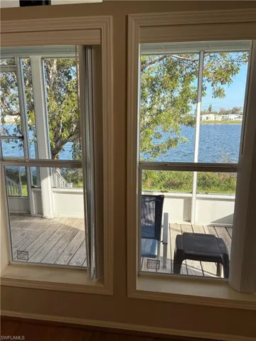 Doorway to outside featuring a water view and wood-type flooring