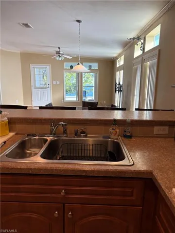 Kitchen featuring sink, hanging light fixtures, and ceiling fan