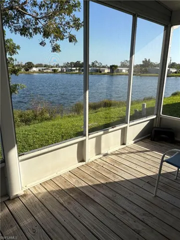 Unfurnished sunroom featuring a water view