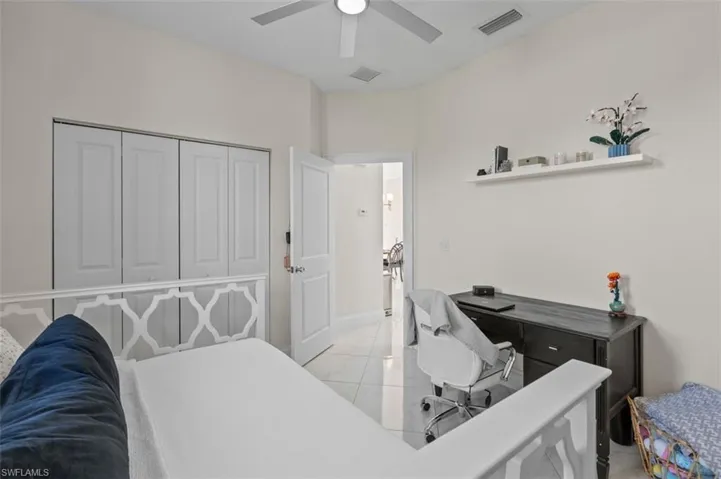 Bedroom featuring a closet, visible vents, ceiling fan, and light tile patterned flooring